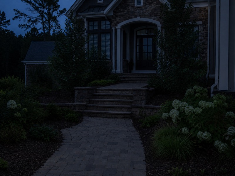 The same new-construction Troutman home facade at dusk before architectural uplighting was installed