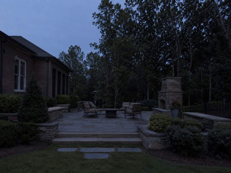 The same Troutman patio and backyard at dusk before outdoor lighting was installed